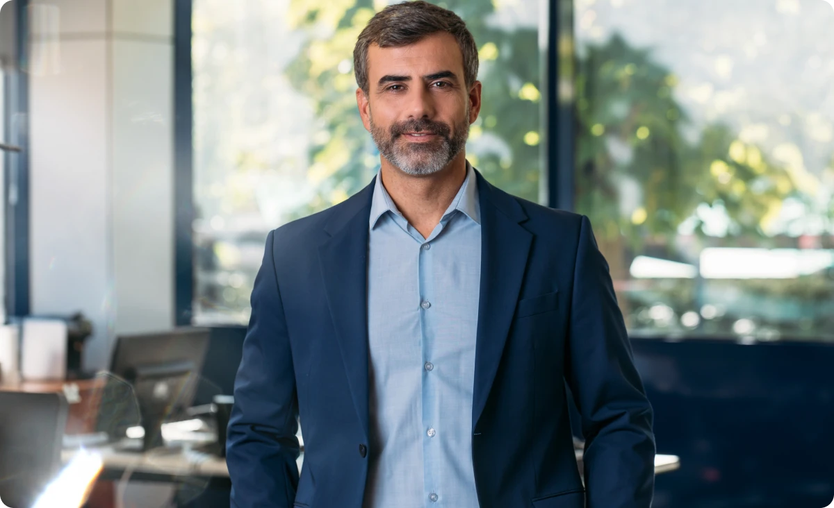 Businessman standing confidently in office